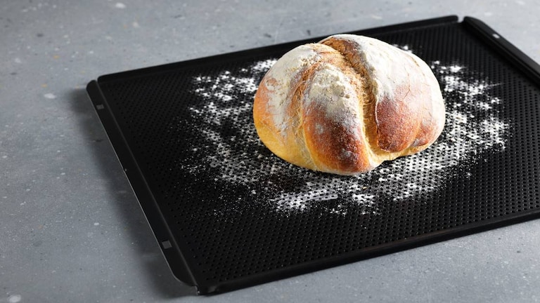Pane cotto su una teglia da forno infarinata