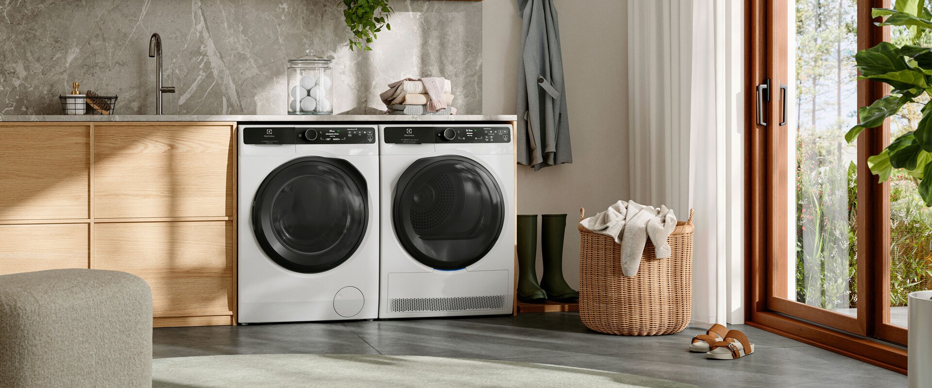 A washing machine and a tumble dryer are placed in a light laundry room.